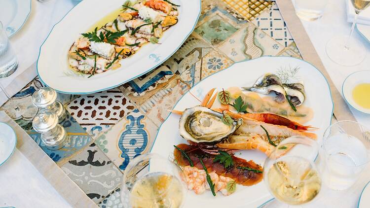 Family style lunch with warm seafood salad and raw fish at Ristorante Sant'Andrea