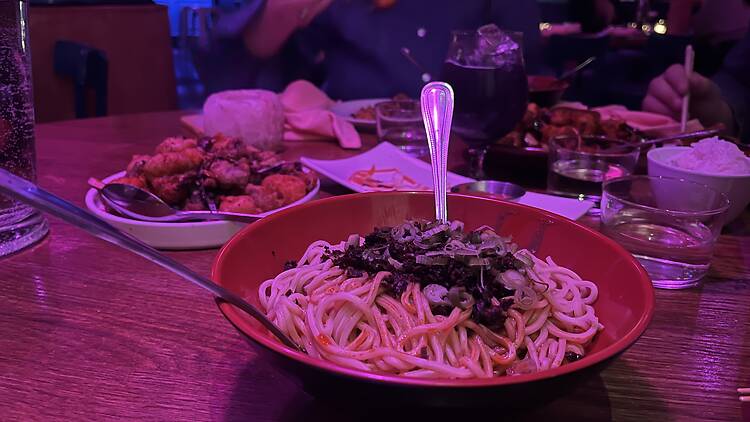 A bowl of noodles on a table 