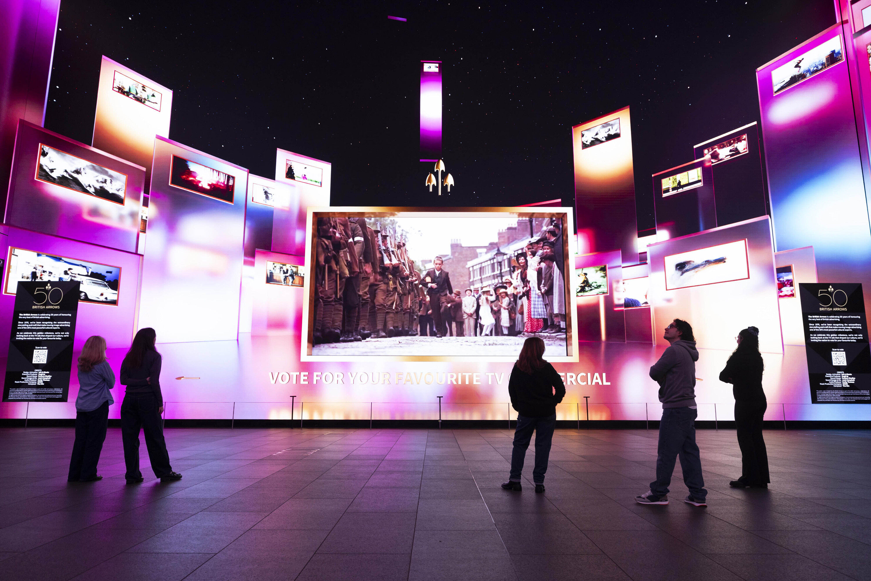 Members of the public looking at the Ads of the Years exhibition at Outernet London, as British Arrows unveils the first major retrospective celebrating 50 years of iconic British TV adverts