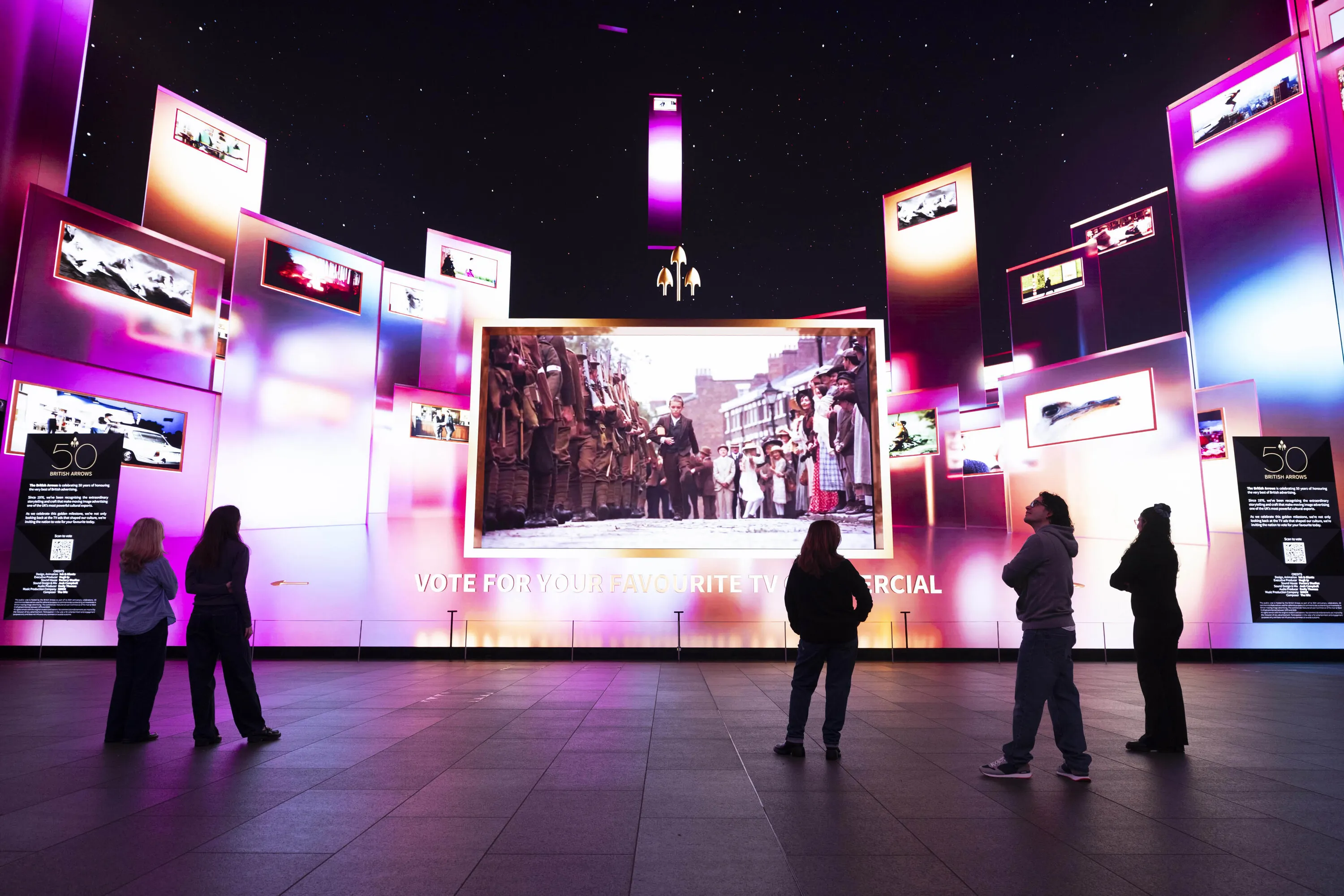 Members of the public looking at the Ads of the Years exhibition at Outernet London, as British Arrows unveils the first major retrospective celebrating 50 years of iconic British TV adverts