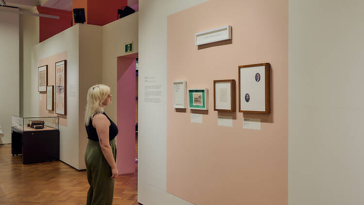 A person looking at art on a wall.