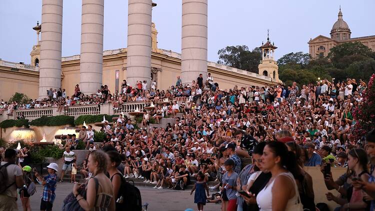 Barcelona, Spain - 07 21 2022: People gathered to see the Magic Fountain of Montjüic built in 1929 (Plaça de Carles Buïgas) post covid-19
