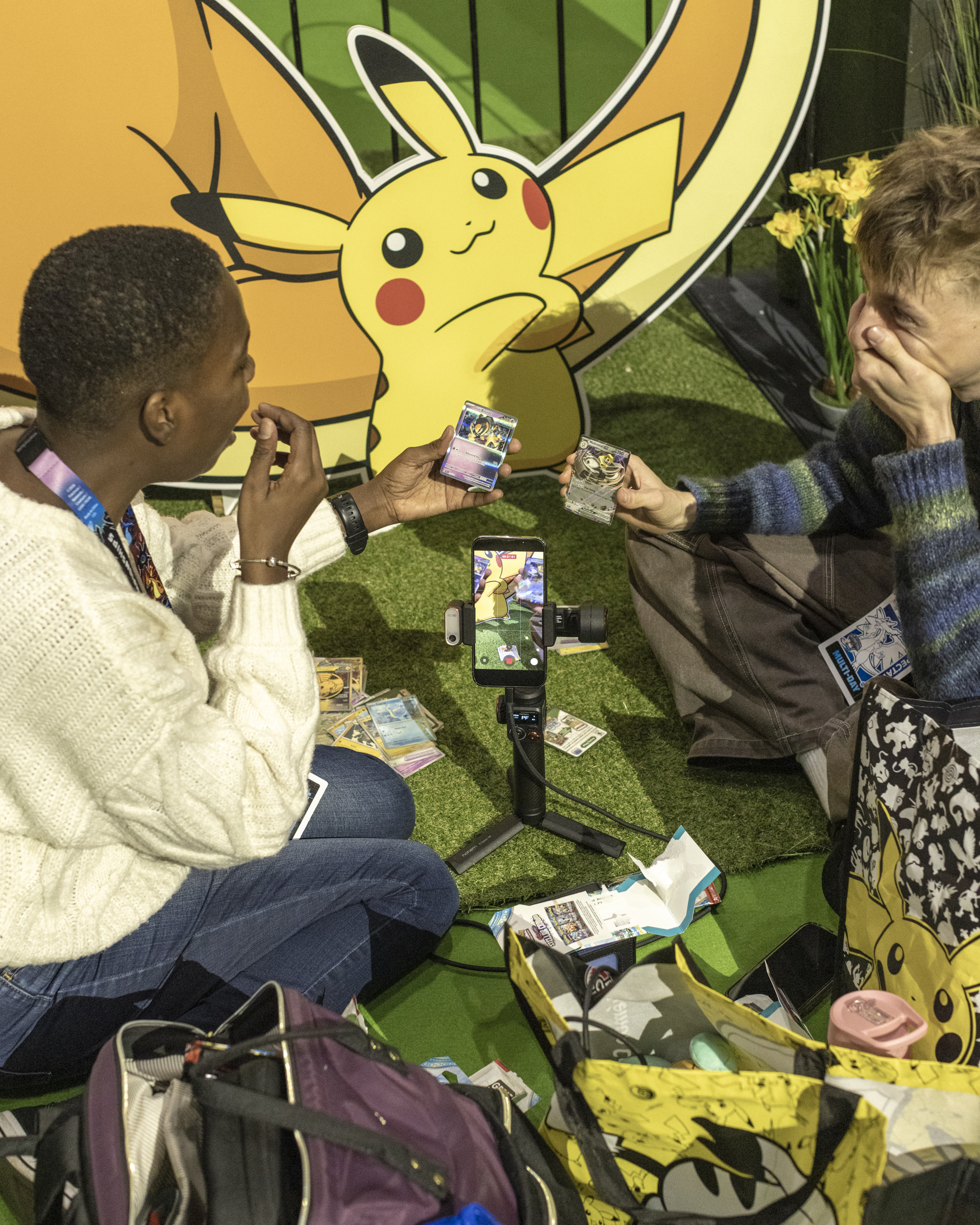 Friends showing Pokemon cards at the Pokemon championships
