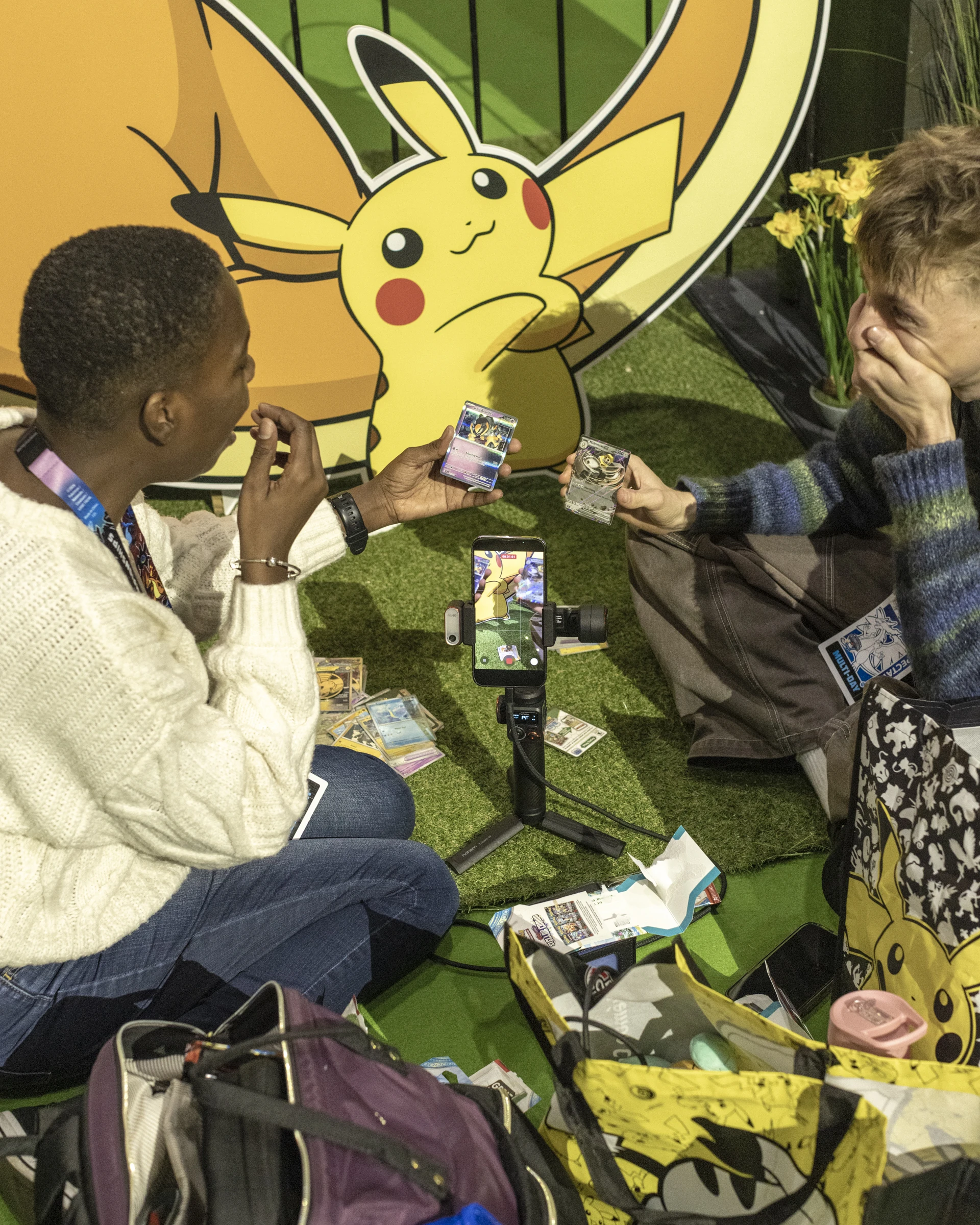 Friends showing Pokemon cards at the Pokemon championships