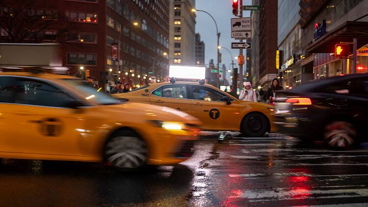 Taxis driving down busy New York City streets