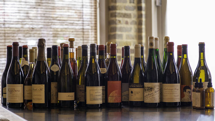 A host of wine bottles on a bar