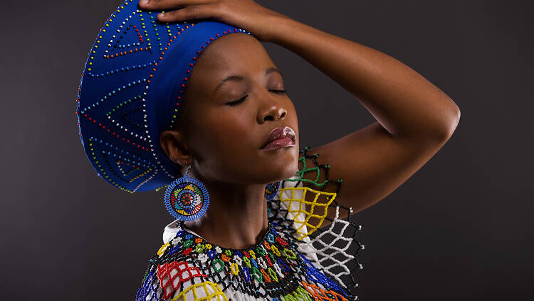 African woman in traditional clothes with eyes close