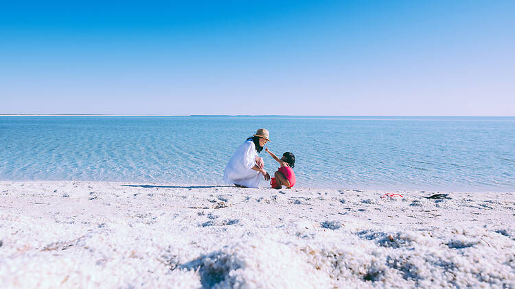 Mother and daughter on Shell beach in the Shark bay World Heritage Area.