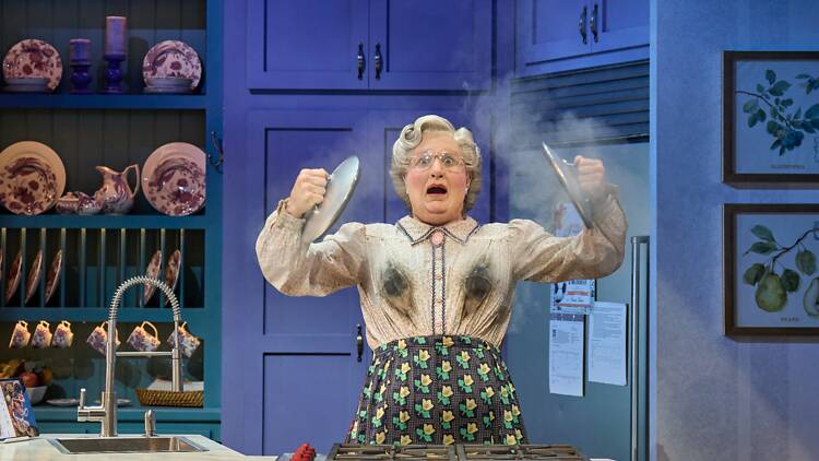 Person dressed as Mrs Doubtfire on stage in production