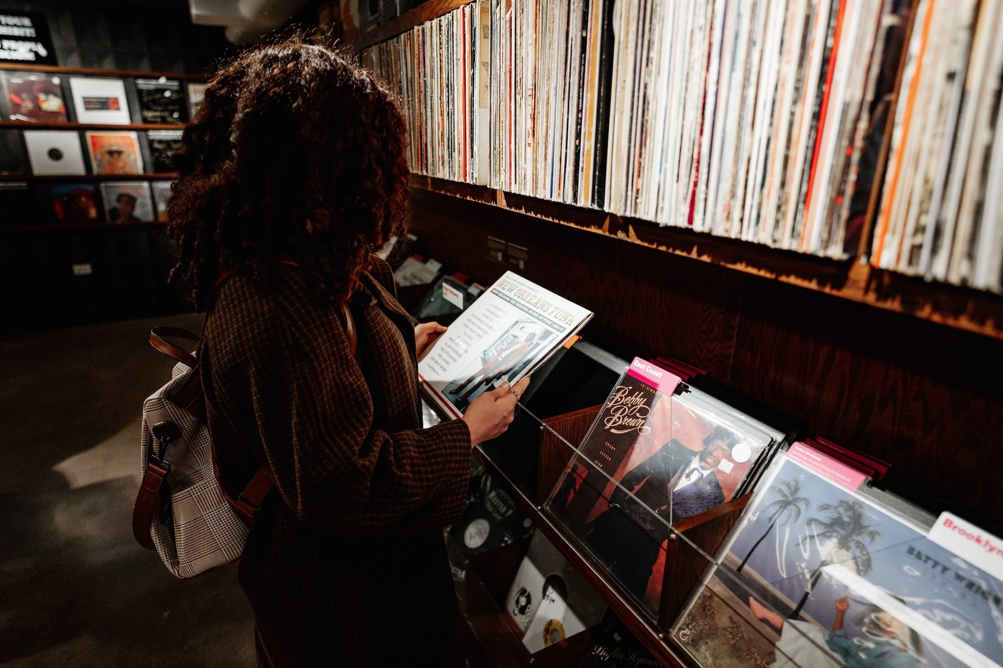 Browsing albums inside the REC Room, curated by DJ Spinderella, at the National Public Housing Museum. 