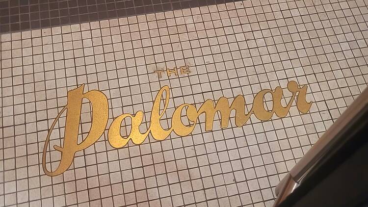 Floor tiles with 'The Palomar' wording in gold