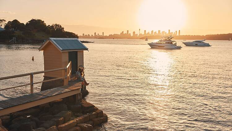 Family enjoying some food on the jetty at Camp Cove in Watsons Bay, Sydney