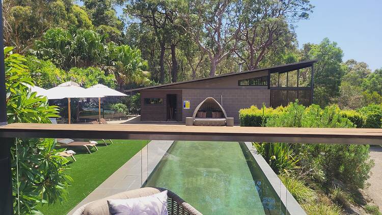 A photo of a pool taken from a deck above.