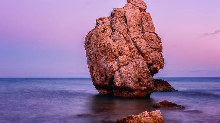 Take a sunset beach stroll by Aphrodite’s Rock