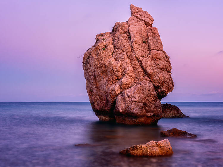 Take a sunset beach stroll by Aphrodite’s Rock