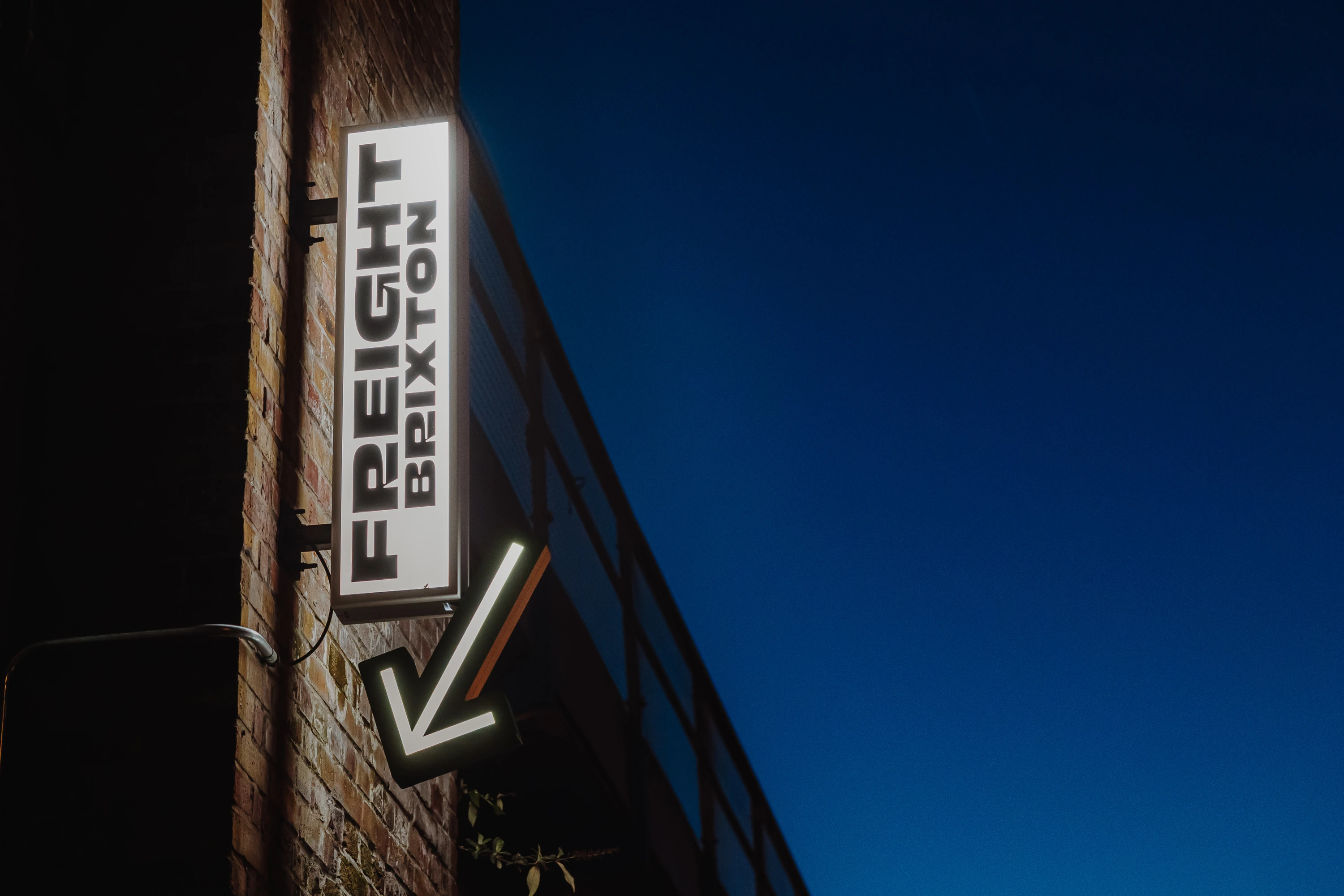 Freight Brixton sign against night sky
