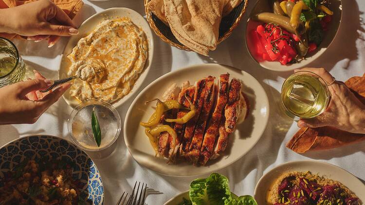 Lebanese food at Sahtein restaurant in The Rocks with hummus, flatbread, chicken, pickled chillies, meats