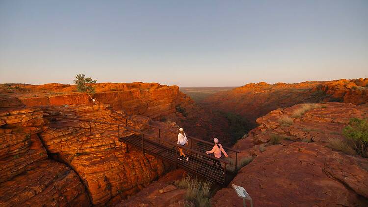 Two women walking near canyon