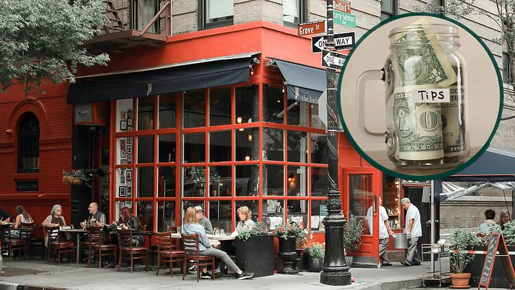 a group of people sitting at tables outside of a restaurant