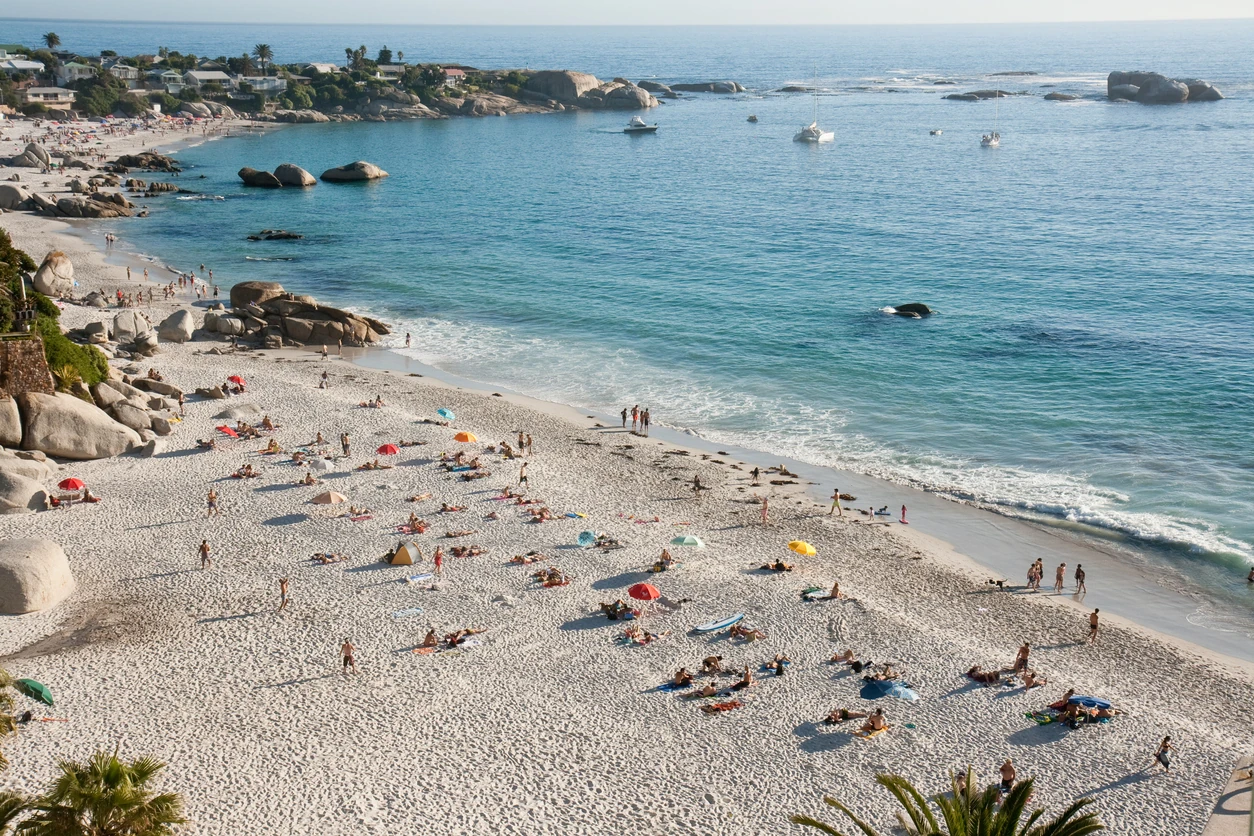 Crowds throng Clifton Beach, Cape Town, to soak up the sun and paddle in the Atlantic ocean. The beach is a popular hang-out for tourists and locals alike.