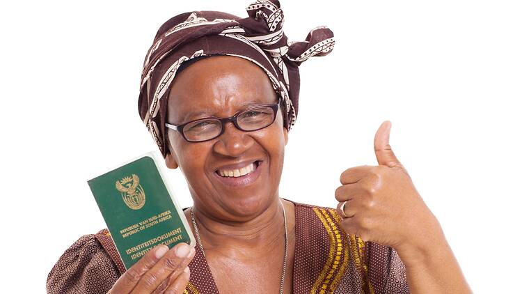 Happy senior south african woman holding identity document