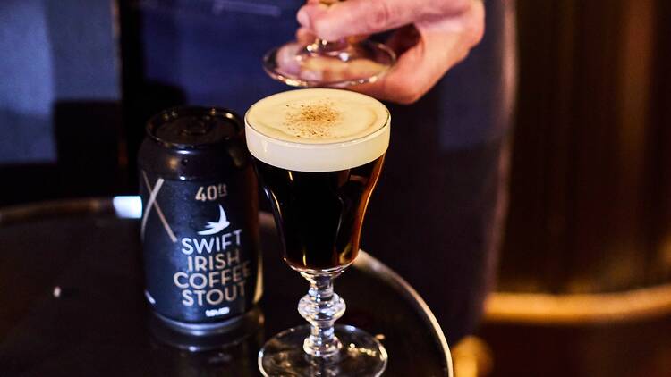A can of Swift x 40FT Brewery Irish Coffee Stout sitting on a table next to a Swift Irish coffee