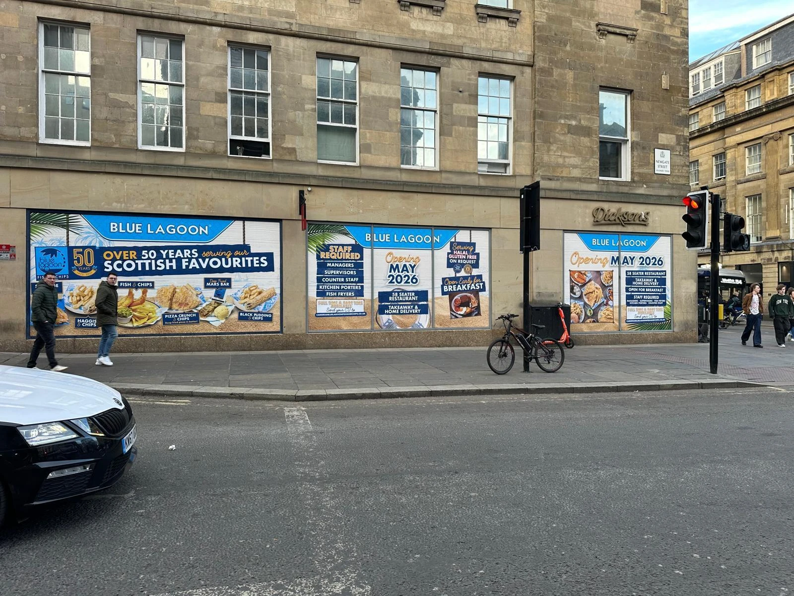 Storefront of Blue Lagoon in Newcastle with window signs advertising job openings