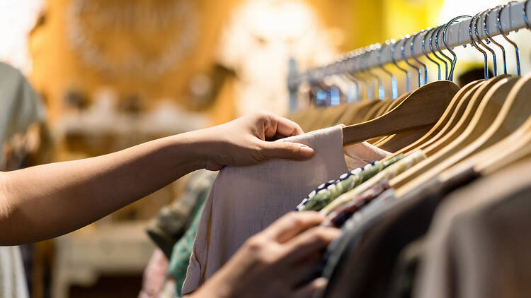  Woman choosing t-shirt clothes in store