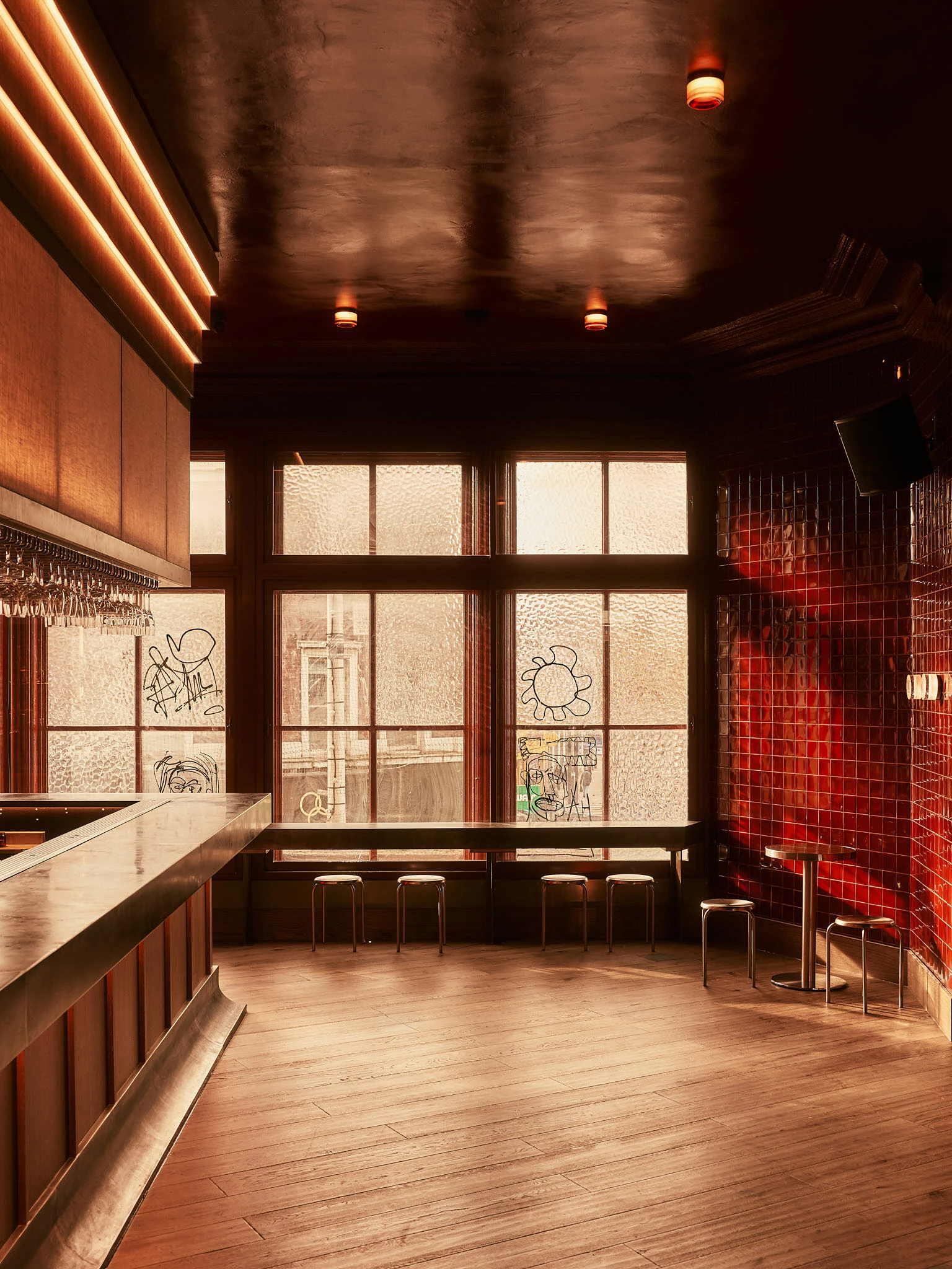 Empty bar with graffiti on windows looking out to street