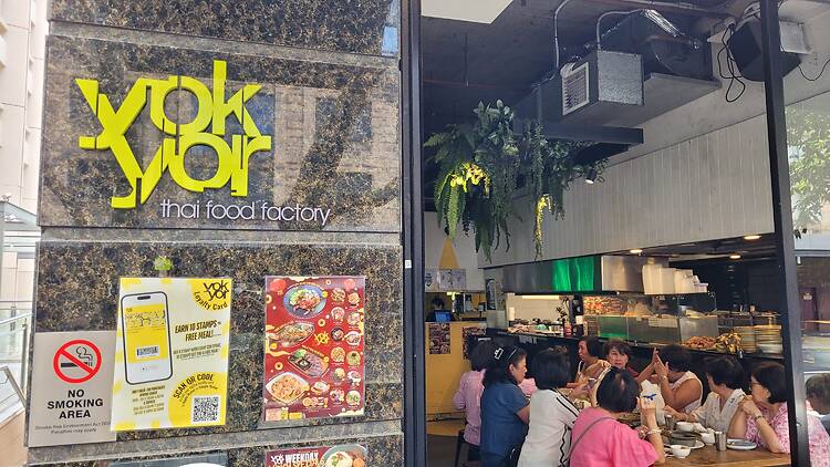 A restaurant with a sign that says: yok yor thai food factory