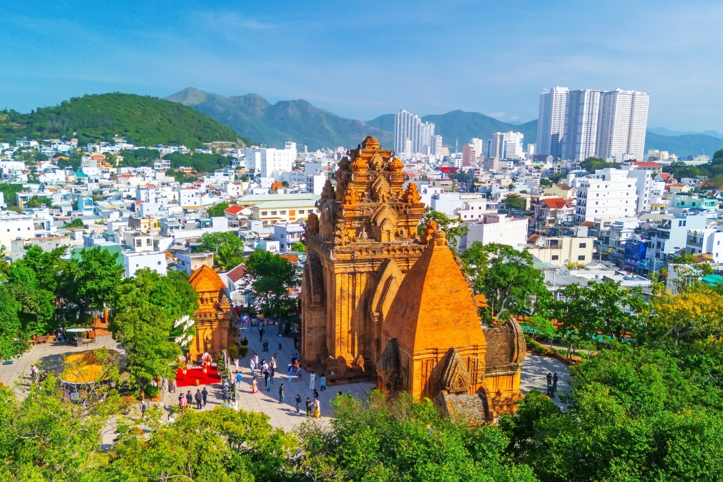 Aerial view of Ponagar tower in city at morning time among the urban development. Vietnam, Nha Trang.