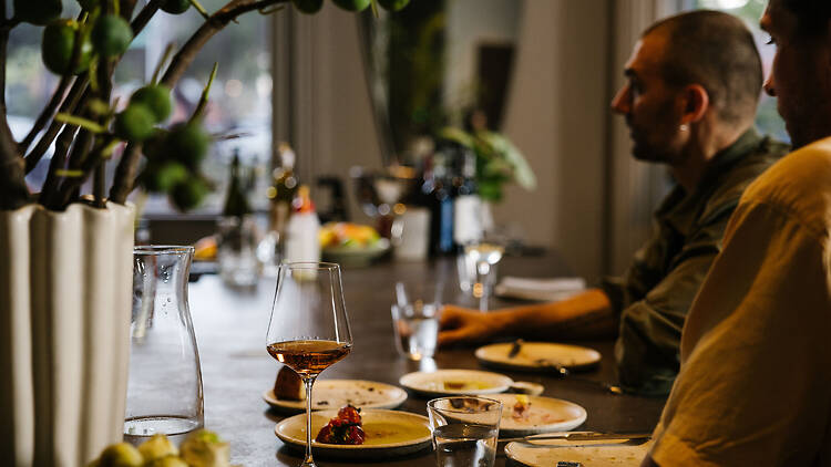 People dining at the bar at Suze.