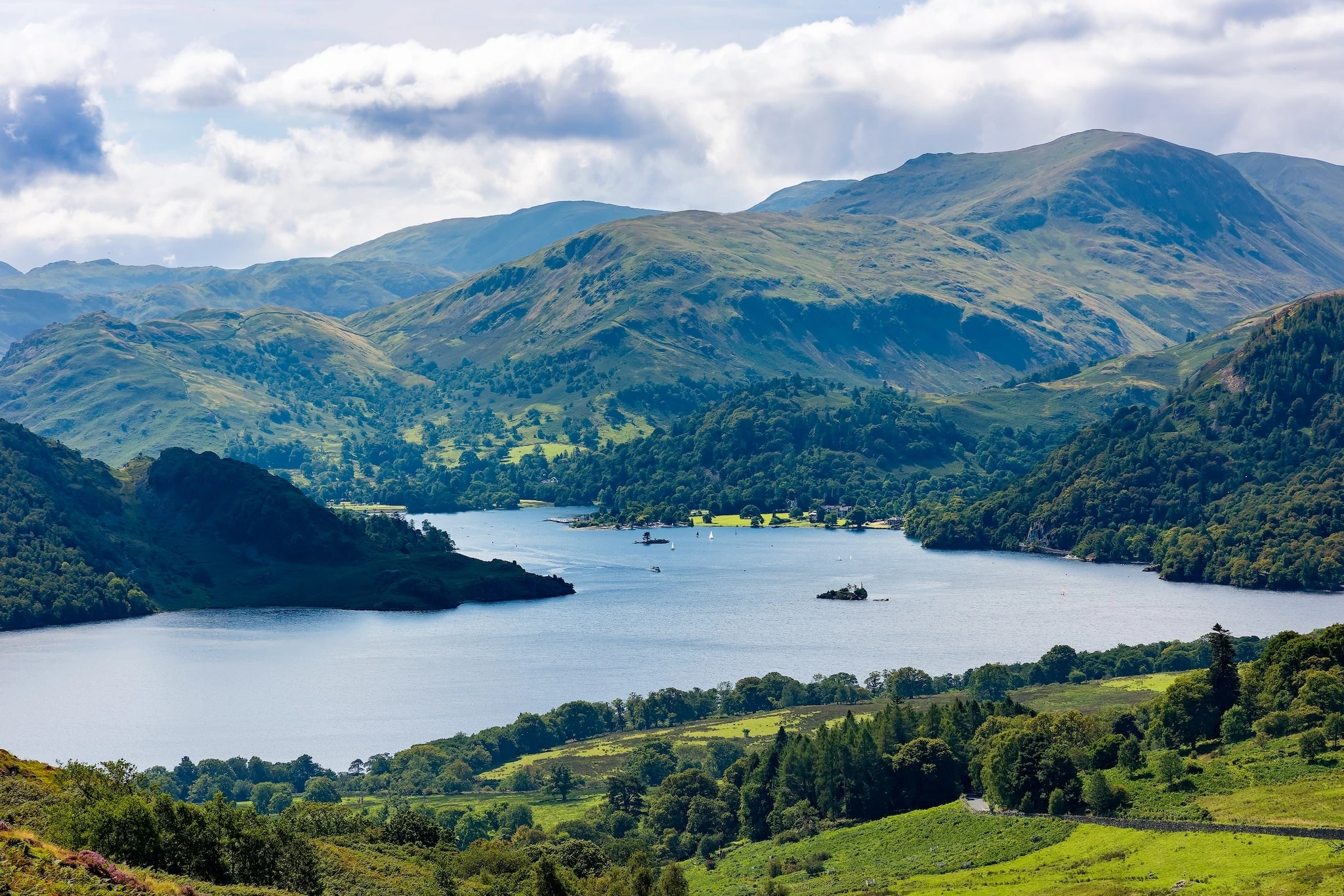 View from Gowbarrow Fell over Ullswater lake and distant fells in summer