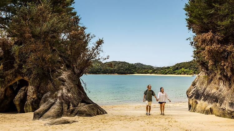A couple on a beach in New Zealand