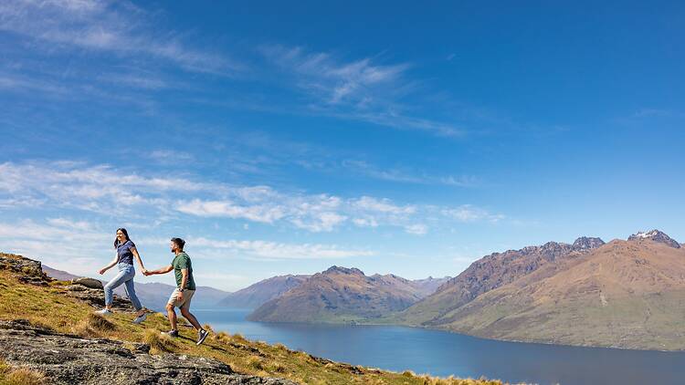 A couple climbing a mountain in New Zealand
