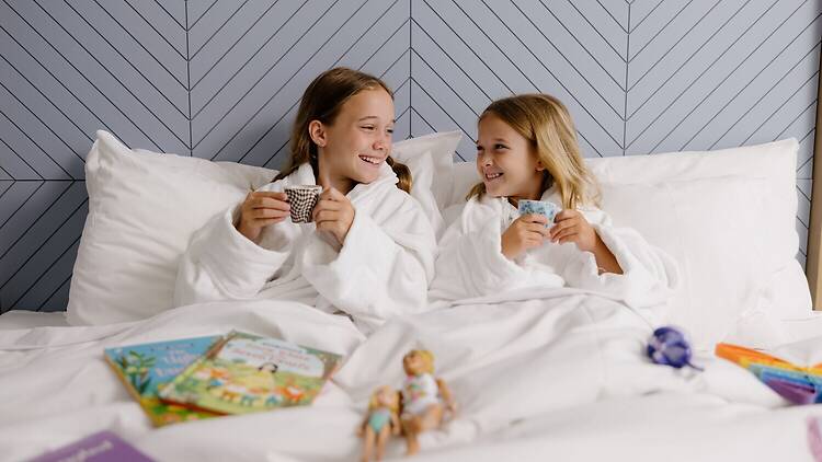 Girls having breakfast in bed 