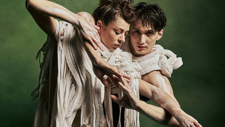 Two ballet dancers holding each other.