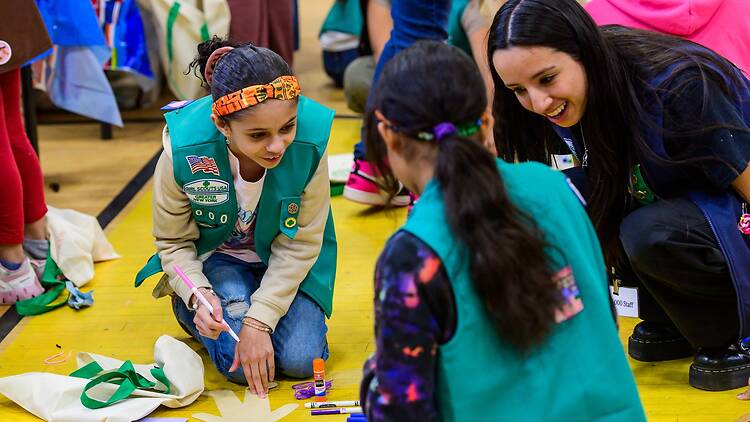 Two girl scouts making crafts