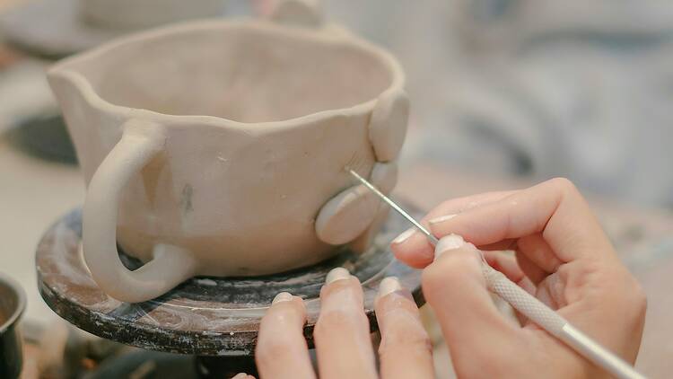 A woman making a mug