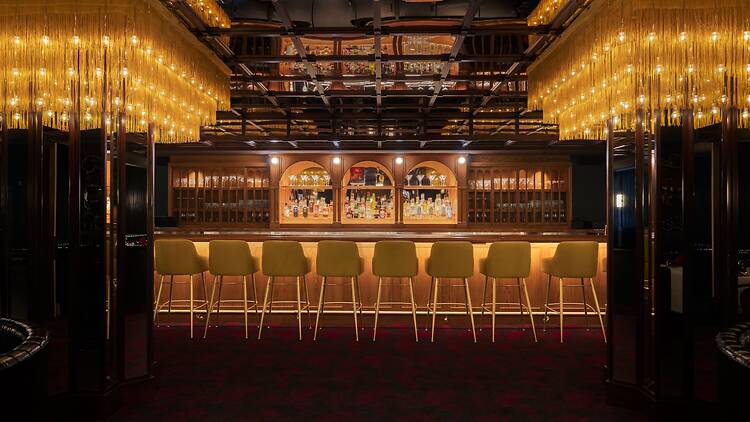 A bar with a mirrored ceiling and fringe