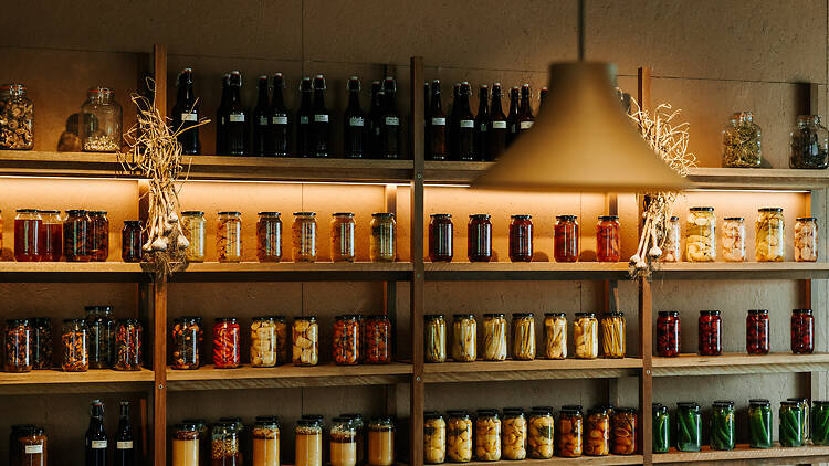 Shelves of pickled fruits and veggies in jars at Barragunda.