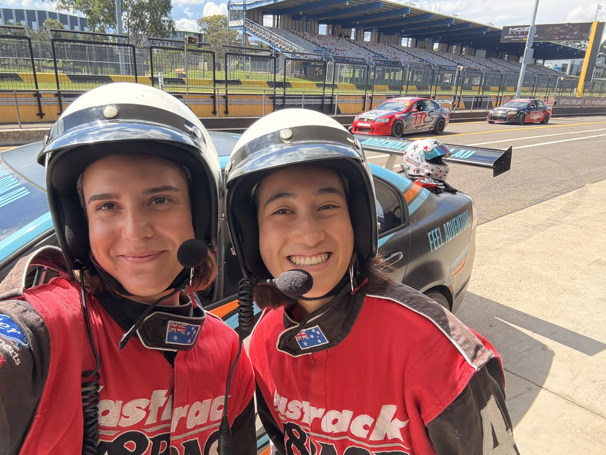 Girls in front of race car