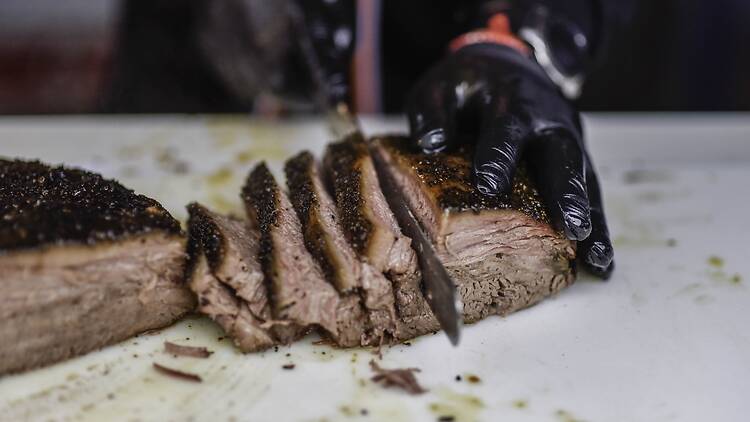 A person slicing brisket