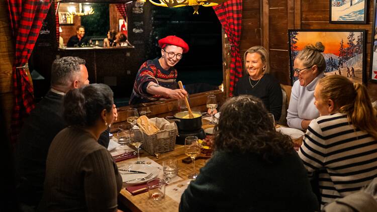 People eating fondue in a chalet.