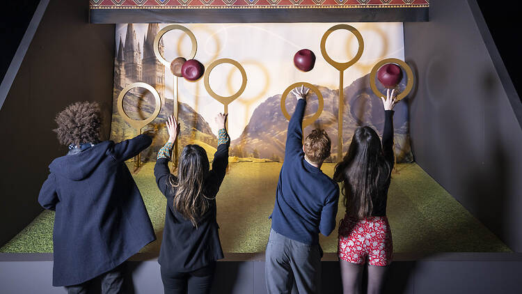 children trying to play Quidditch in Harry Potter: the Exhibition