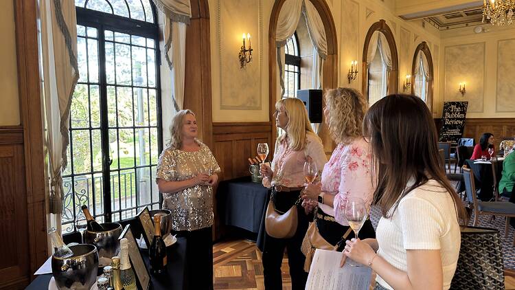 Women talking and tasting bubbles and Champagne
