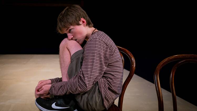 Beyond the Neck Freddy Collyer sitting on a chair in 'Beyond the Neck'.