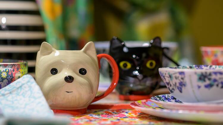 Ceramic mugs shaped like a westie dog and a black cat, designed by Sarah Campbell