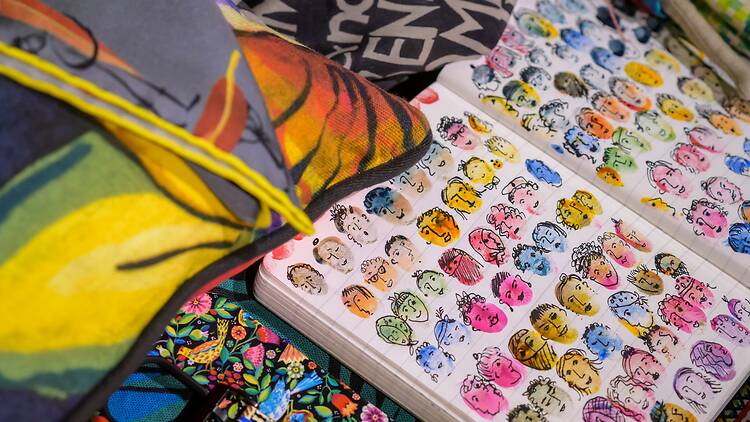 A notebook filled with finger-painted faces