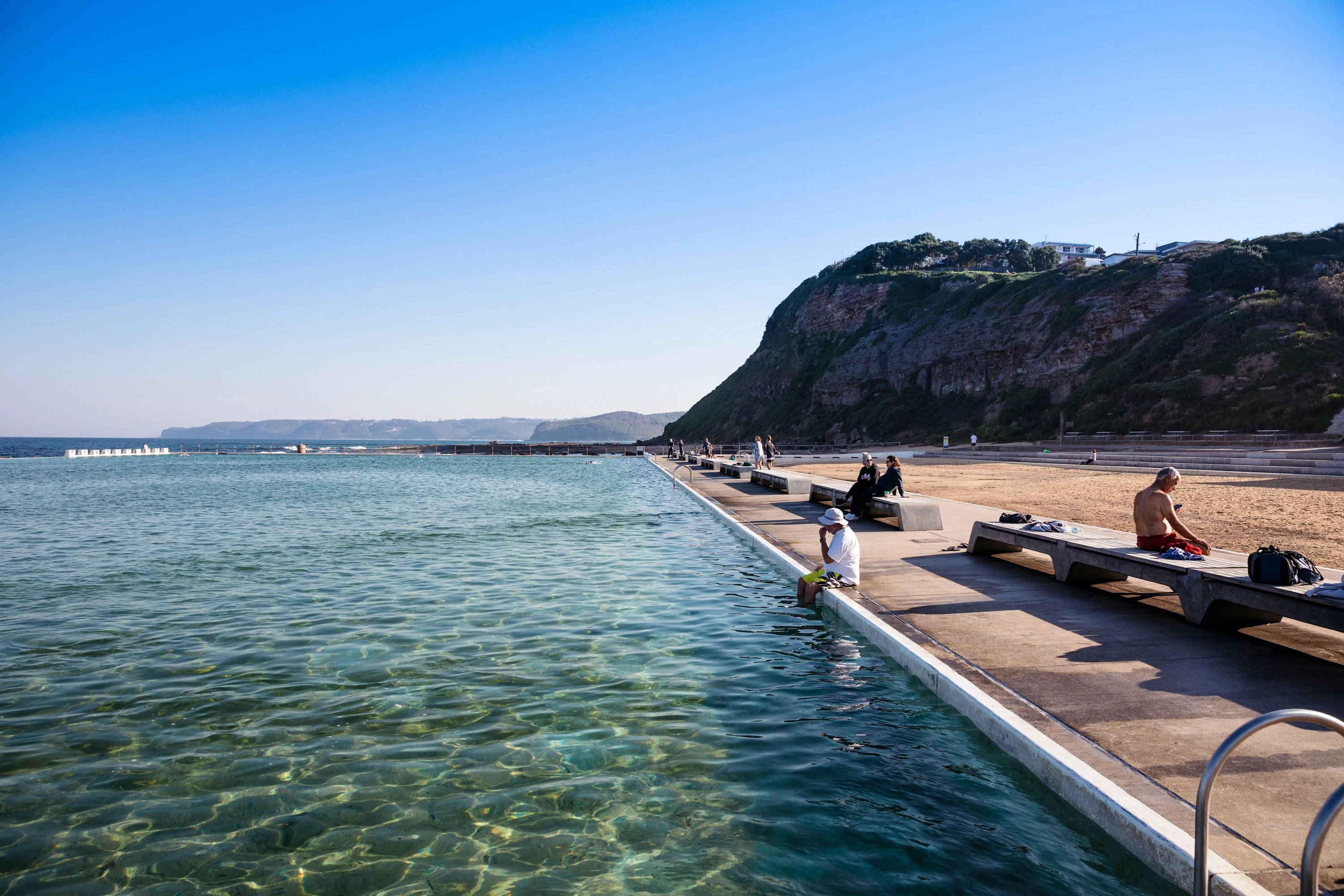 People relaxing at Merewether's Ocean Baths in Newcastle.
